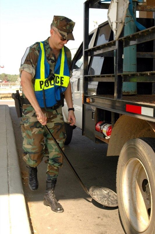 Under-vehicle inspection mirror at a security checkpoint