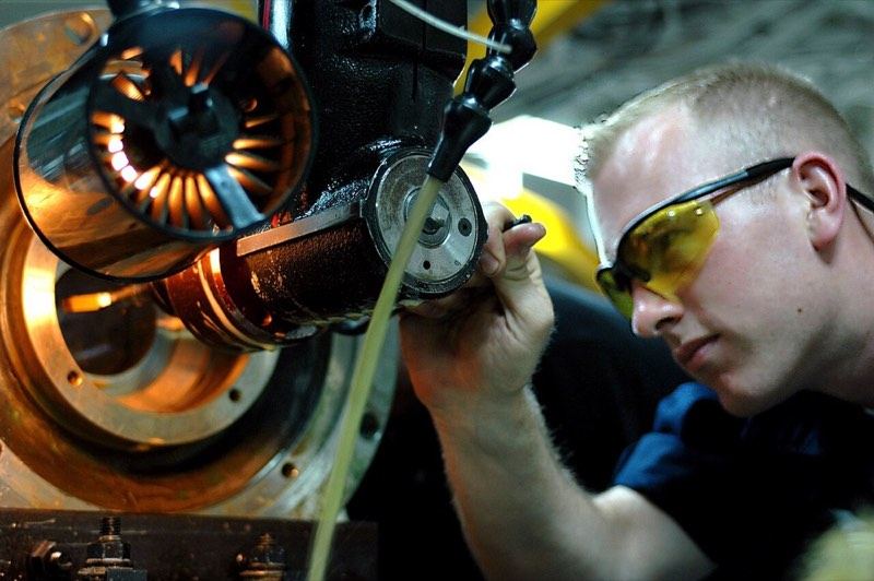 Technician repairing an industrial equipment